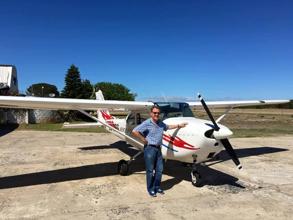 Daniel in front of a Cessna 172 in South Africa, where he first earned his pilot's license.